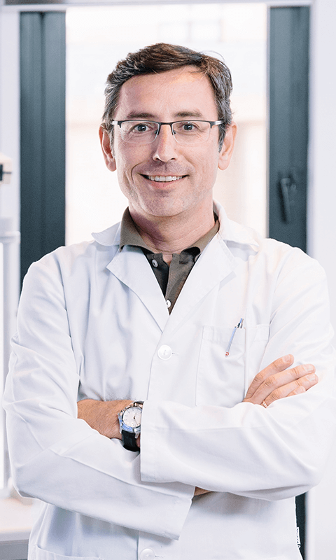 portrait-of-handsome-eye-doctor-sitting-with-ophth-2022-01-11-14-50-36-utc